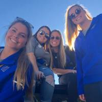Lacrosse players pose for a photo at the tailgate